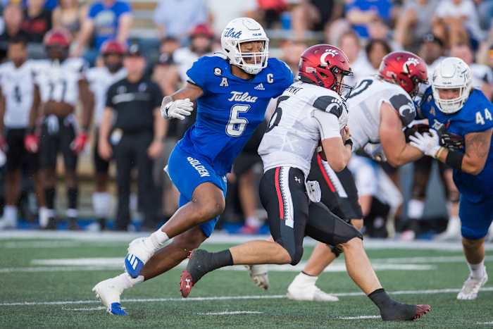 Oct 1, 2022; Tulsa, Oklahoma, USA; Tulsa Golden Hurricane linebacker Jon-Michael Terry (6) tackles Cincinnati Bearcats quarterback Ben Bryant (6) during the first quarter at Skelly Field at H.A. Chapman Stadium. Mandatory Credit: Brett Rojo-USA TODAY Sports
